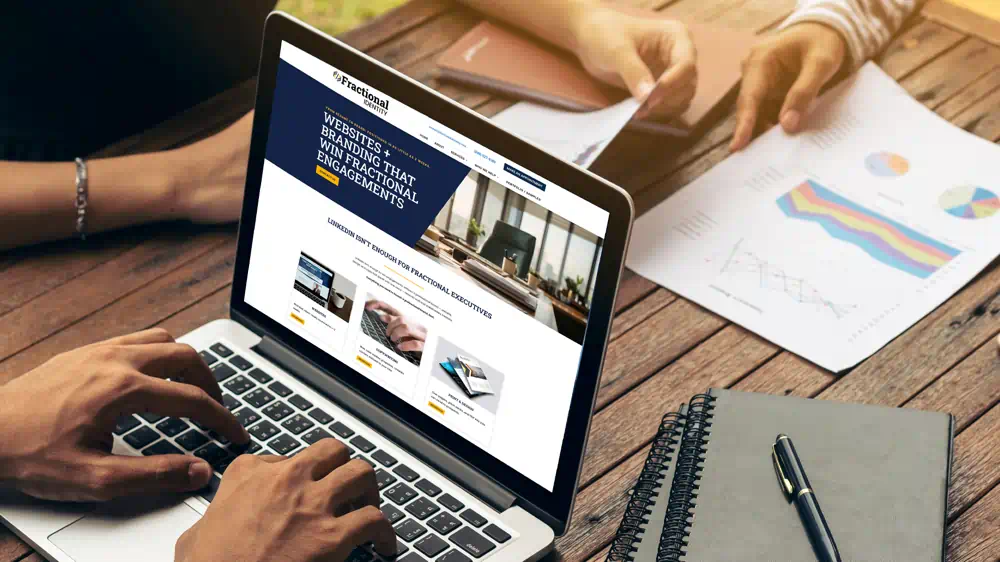 Fractional executives reviewing branding and website design services on a laptop — FAQ support from Fractional Identity